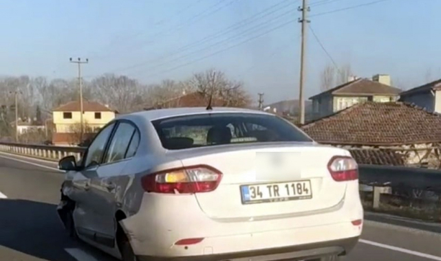 Parçalanmış lastikleri ve yerdeki tampon ile yoluna devam etti